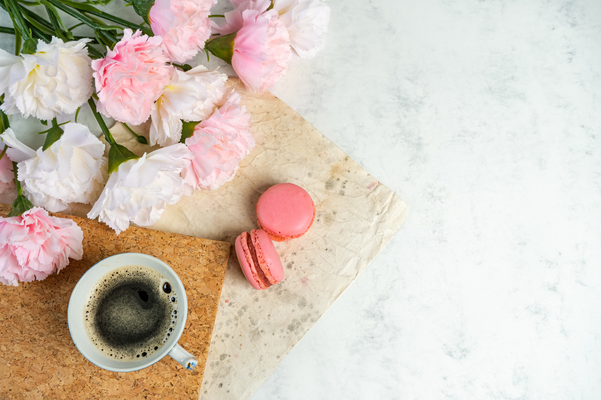 Pink Macarons Beside a Cup of Coffee