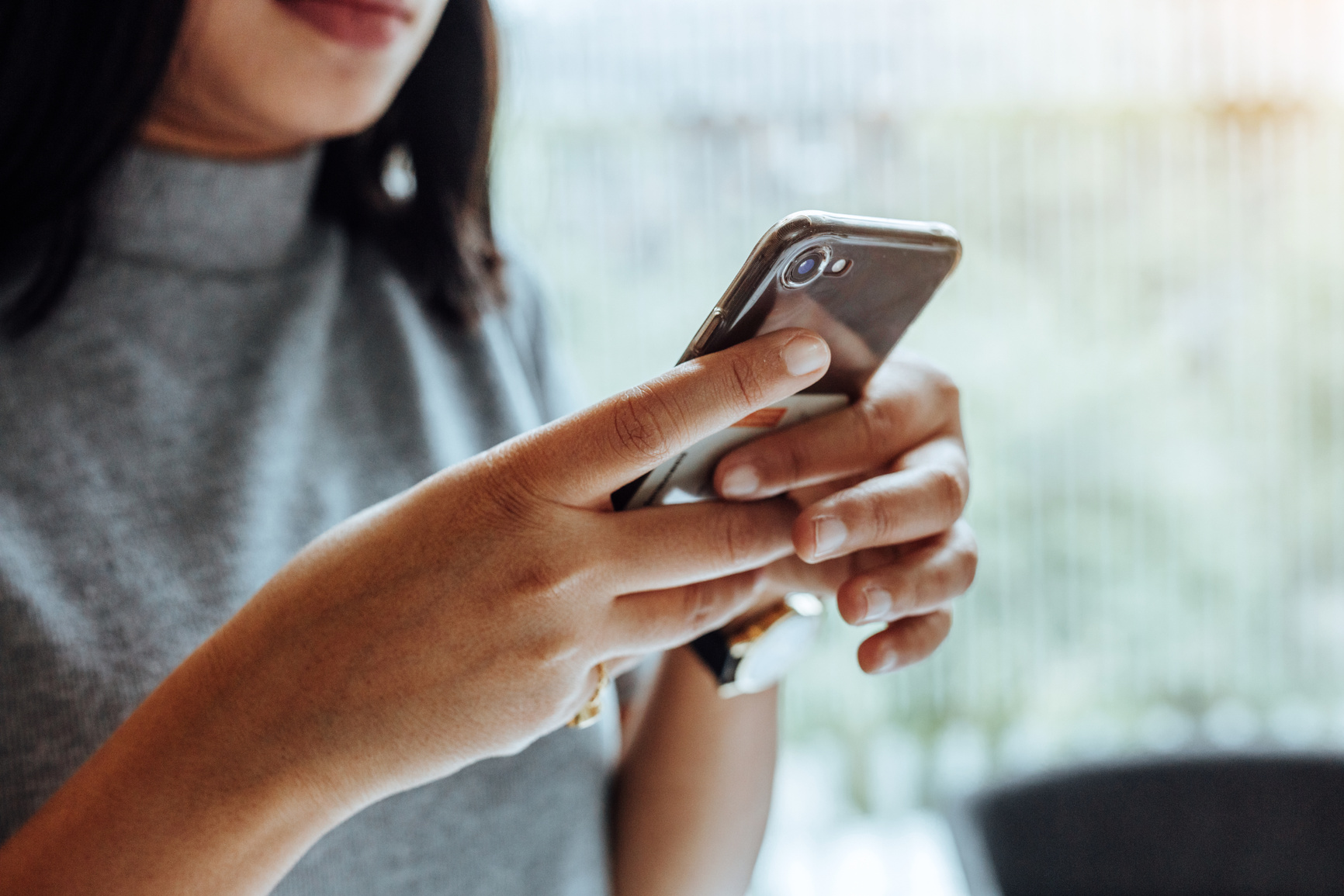 status update, woman holding phone